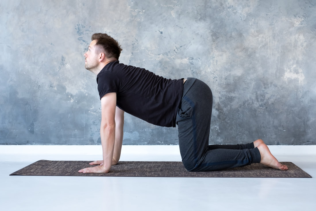 man stretching in cow position